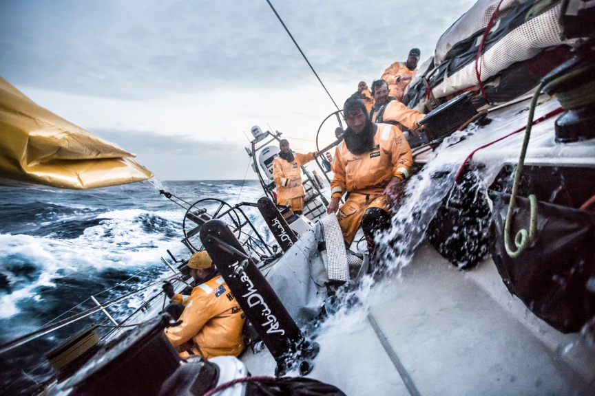 April 1, 2015. Leg 5 to Itajai onboard Abu Dhabi Ocean Racing. Day 15. Louis Sinclair wrestles a sailbag in the cockpit in the midst of a very wet sail peel in the Brazilian Current of the Atlantic Ocean